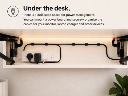 Under-desk cable management area with mounted power board and neatly organised monitor and charger cables.